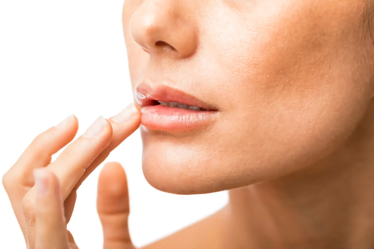 woman applying lubricating lip cream 2025 07 17 19 44 11 utc